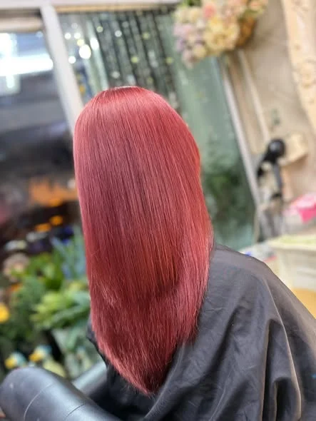 Vibrant Reddish-Pink Hair Color in Bangkok