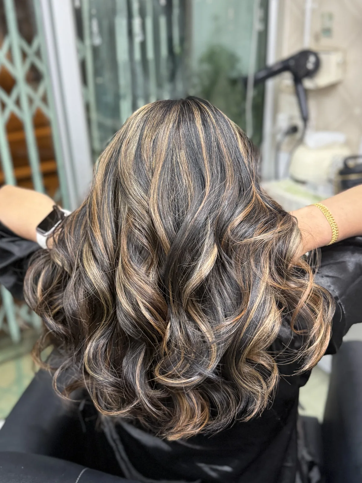 Back view of warm caramel highlights at Oilly Hair Salon Sathorn Bangkok