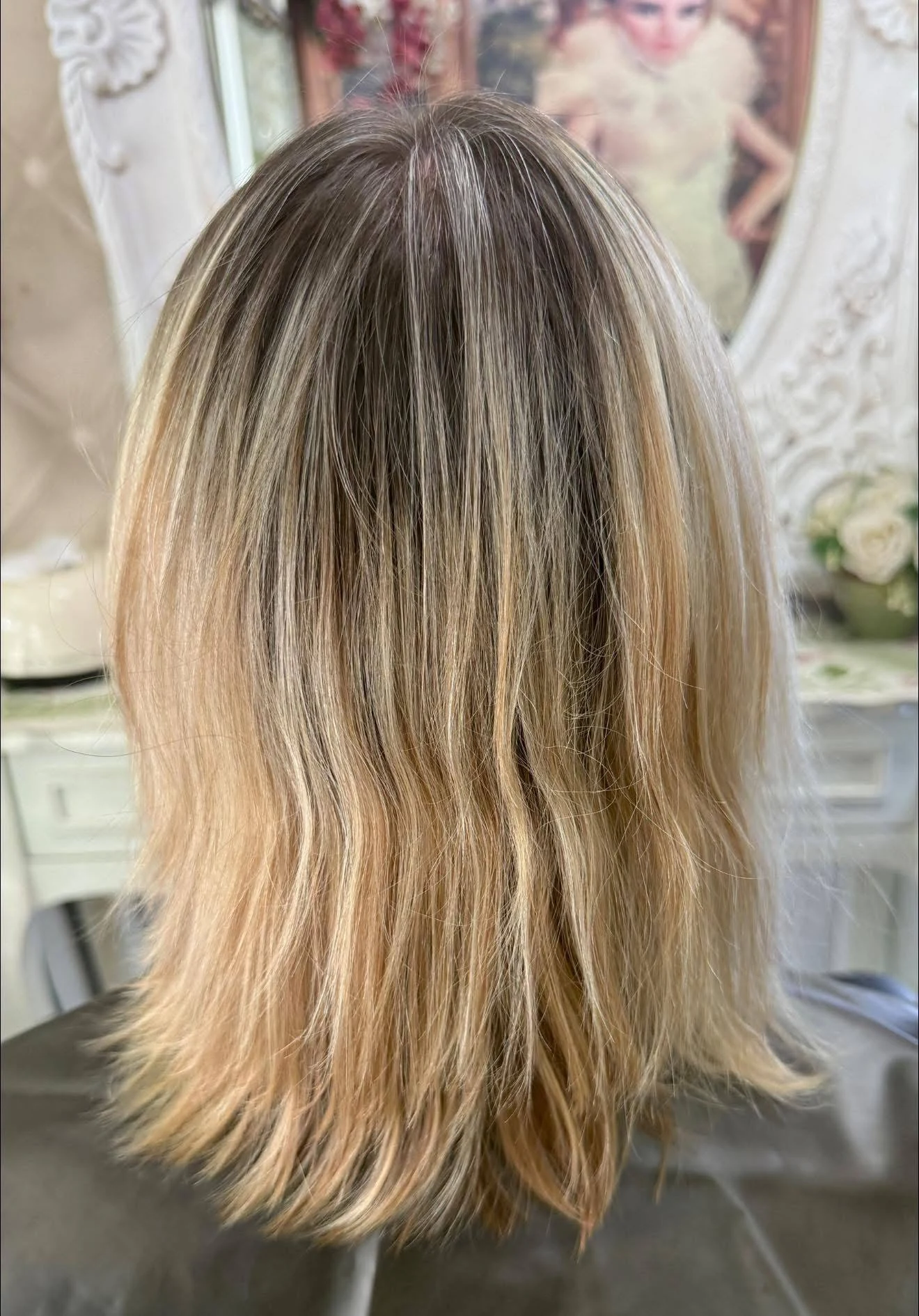 Before cool blonde color service in Bangkok with warmer blonde lengths and darker regrowth