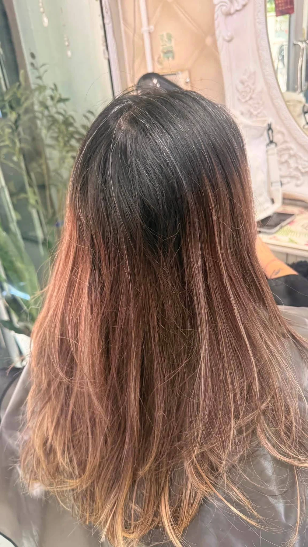 Before photo with grey regrowth and warm uneven colour before ash grey balayage in Bangkok