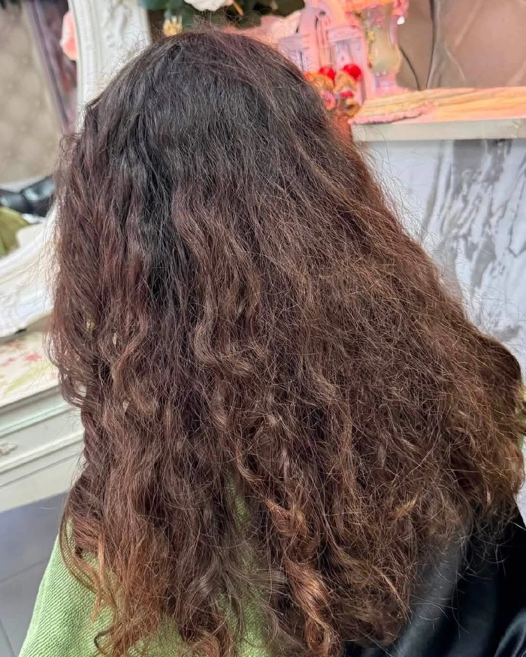 Brown textured hair before a cherry red semi-permanent color service in Bangkok