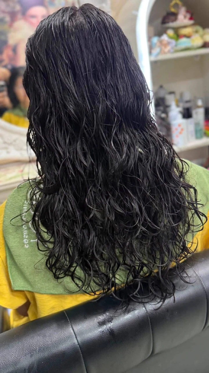 Wet hair result showing the curl pattern and S-wave direction after digital perm processing