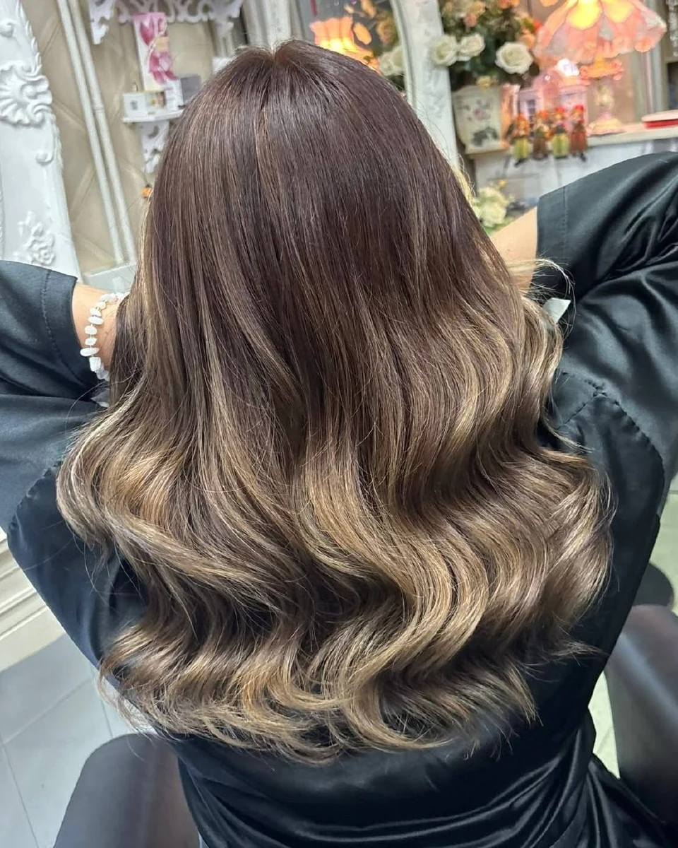 Brown Balayage with dimensional previously lightened ends after color correction in Bangkok