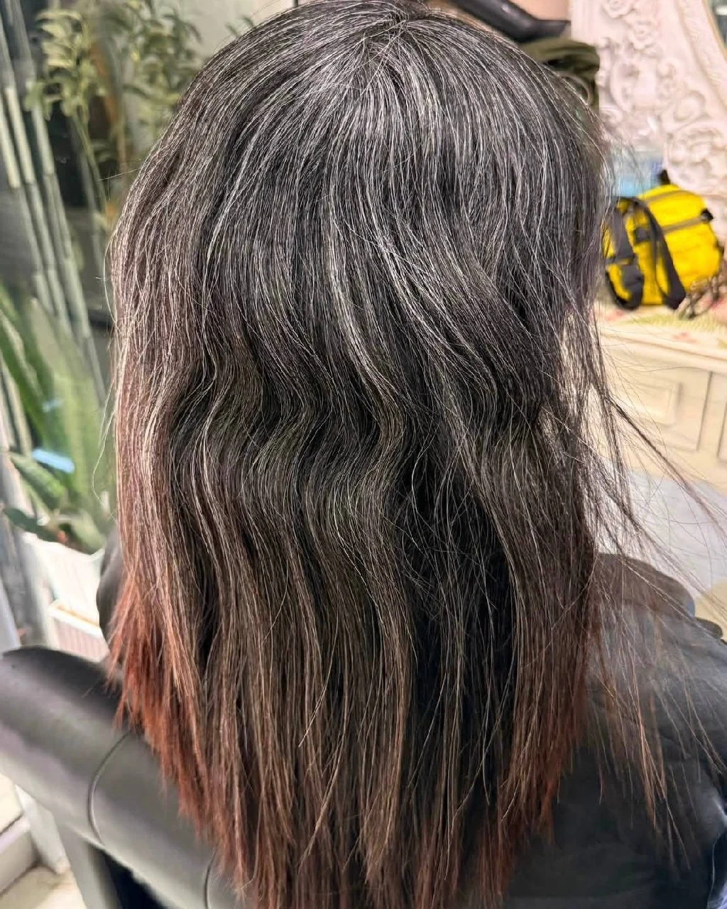 Before grey blending with visible grey regrowth and warm colored lengths in Bangkok