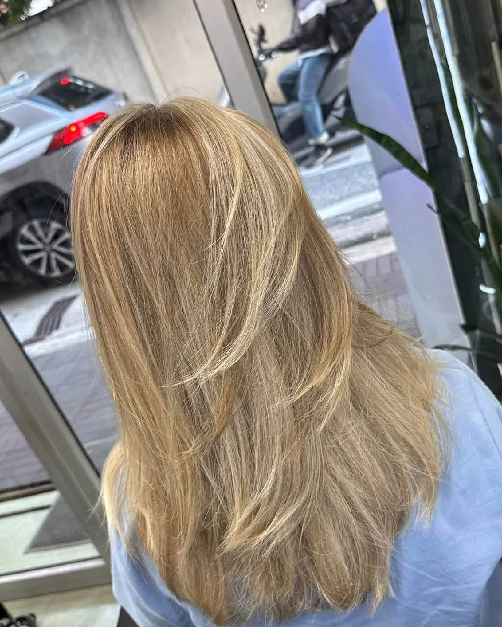 Back result of dimensional light blonde AirTouch Balayage with fine ribbons and layered movement in Bangkok