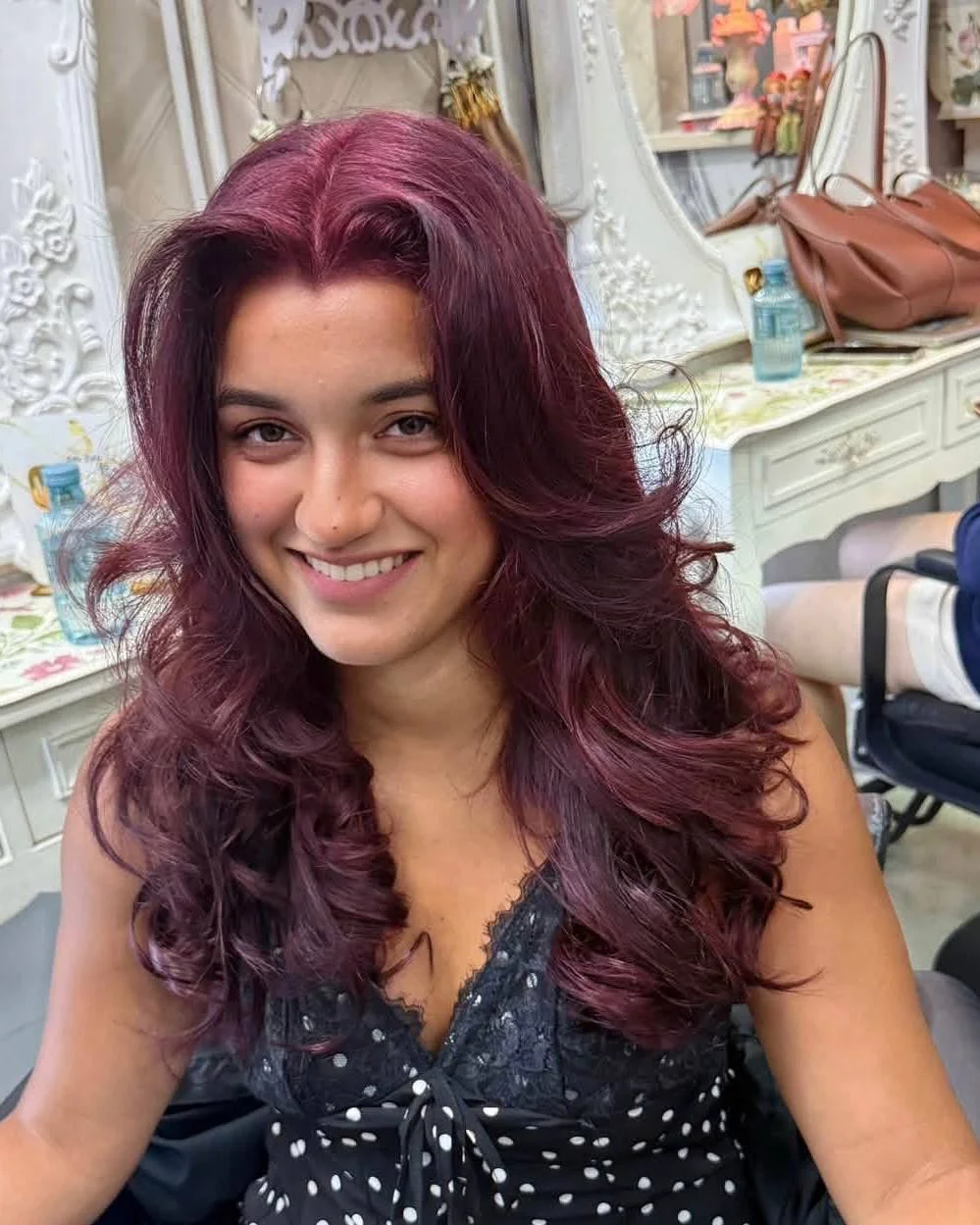 Front result of cherry wine red color correction with face-framing slide layers at Oilly Hair Salon Bangkok