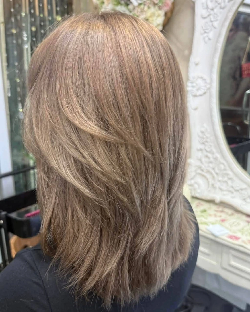 Back result of selective red pigment removal with natural root blending and layered haircut at Oilly Hair Salon Bangkok