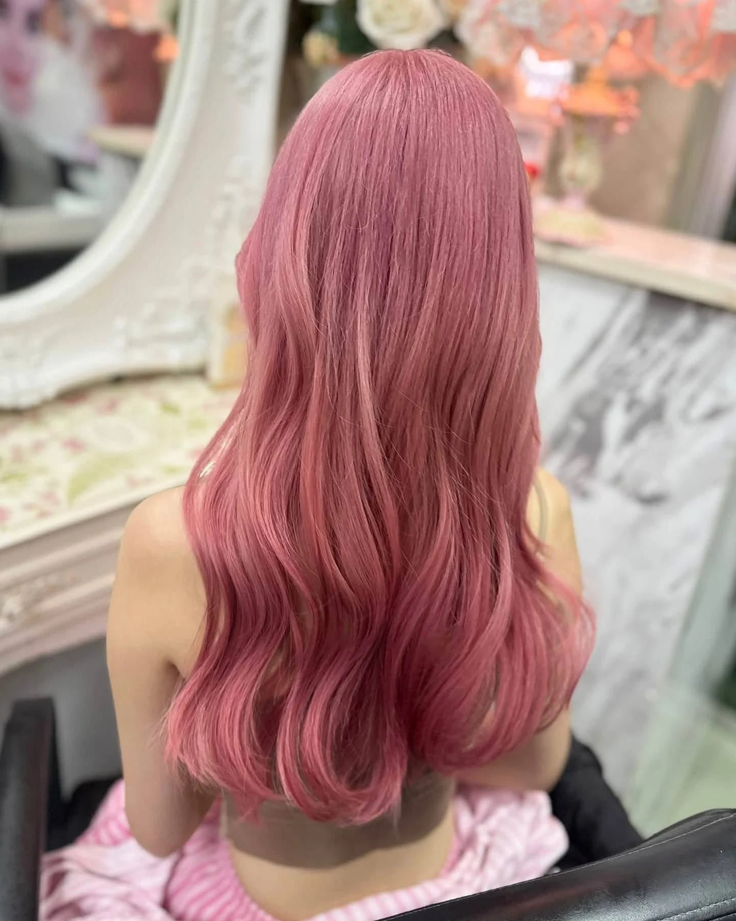 Back view of long layered hair coloured Dusty Rose Pink after two bleach rounds at Oilly Hair Salon Bangkok