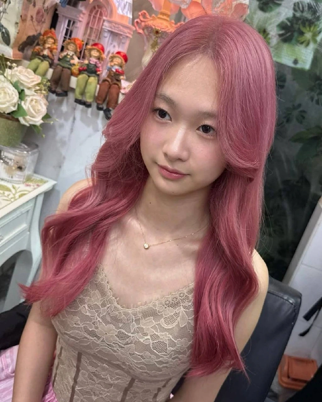 Front view of Dusty Rose Pink hair framing the face of a client with fair, rosy skin, Oilly Hair Salon Bangkok