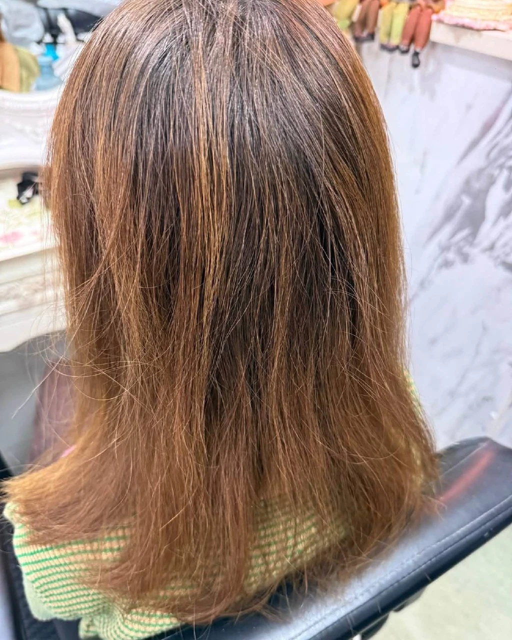 Very fine, frizzy, golden-bright straight hair before a digital perm and toner in Bangkok